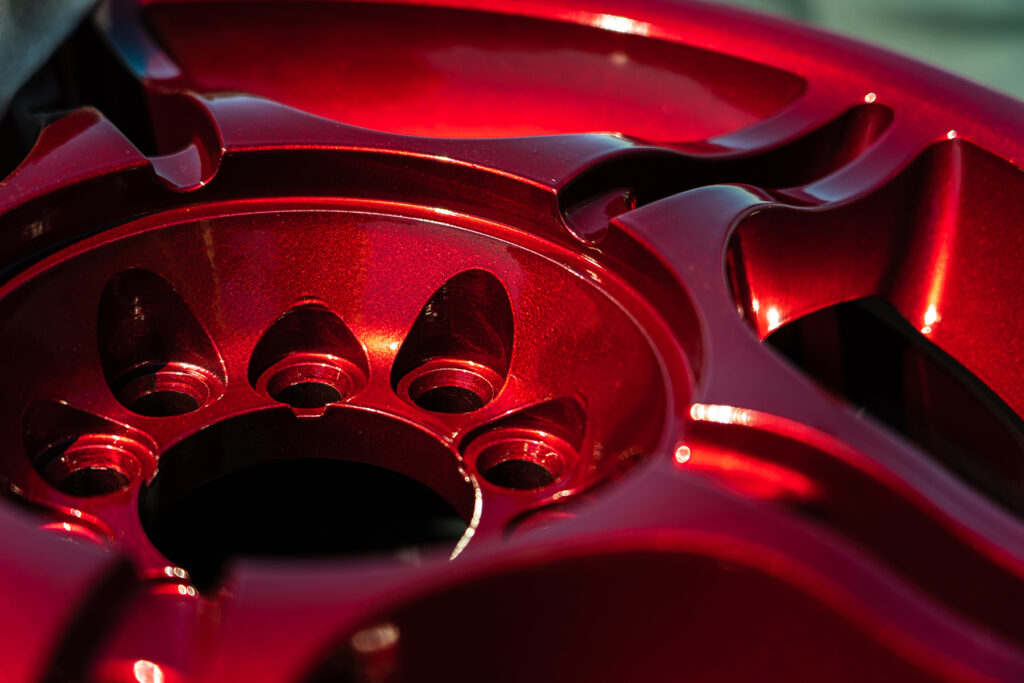 Closeup of Vehicle Rims in Lollipop Red powder coating
